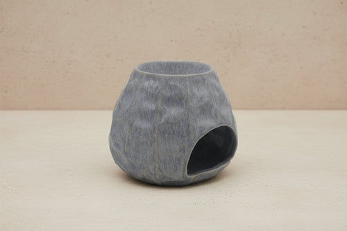 Gray textured burner on a beige concrete background