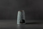 Gray ceramic oil burner on a white background