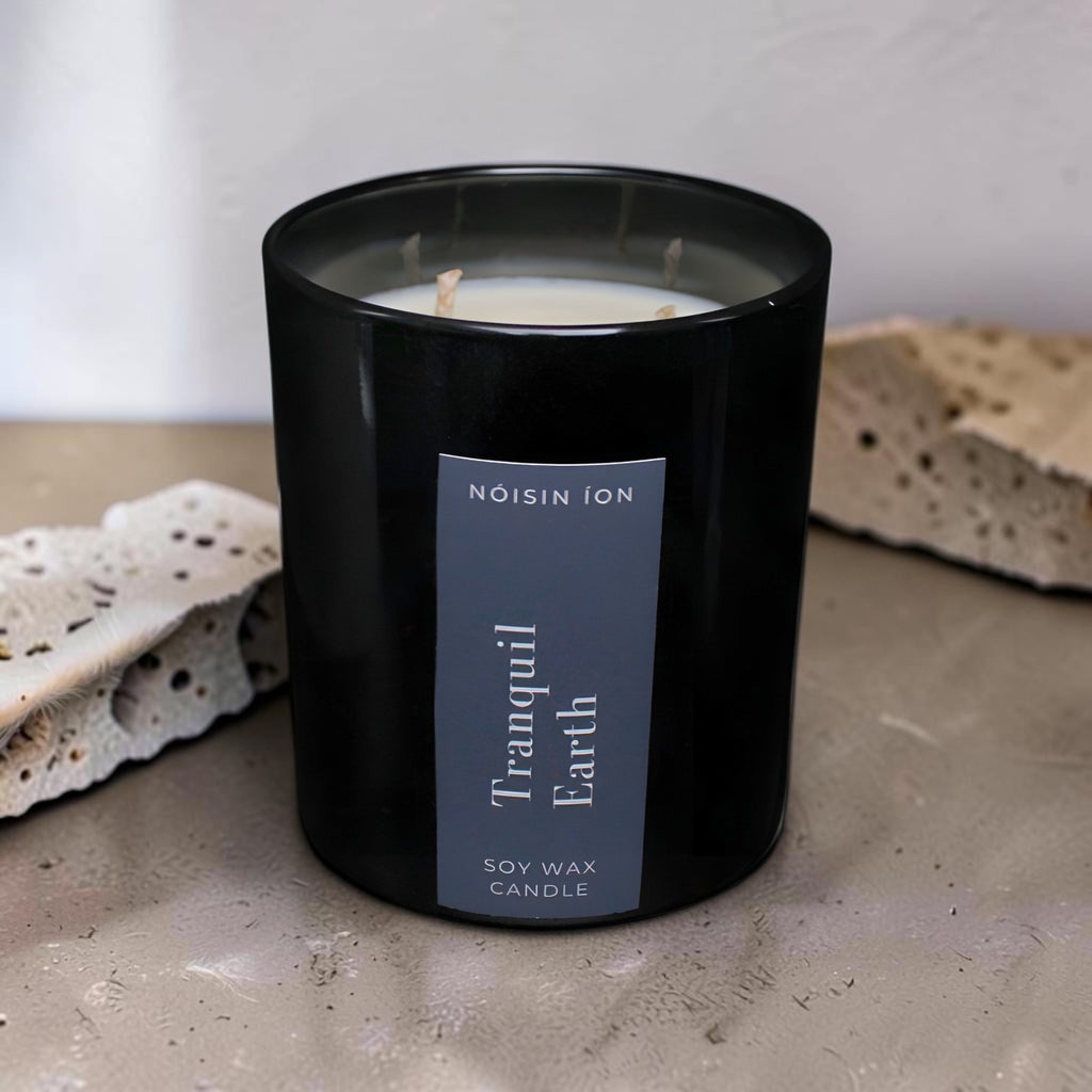 Tranquil Earth luxury soy wax candle in a black gloss jar with a dark navy label by Nóisin Íon.