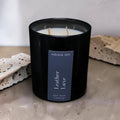 Leather Luxe luxury soy wax candle in a black gloss jar with a dark navy label by Nóisin Íon.