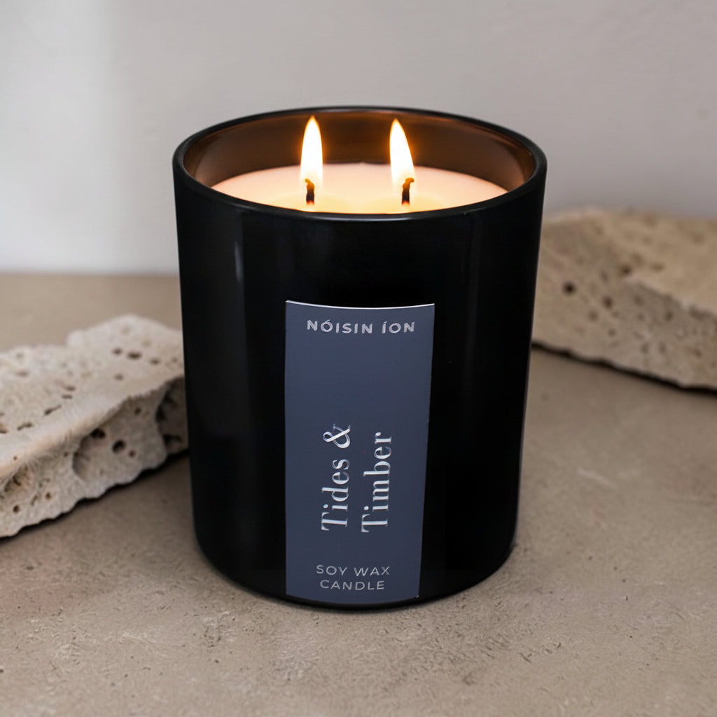 Lit Tides & Timber luxury soy wax candle in a black gloss jar inspired by coastal forests and driftwood by Nóisin Íon.