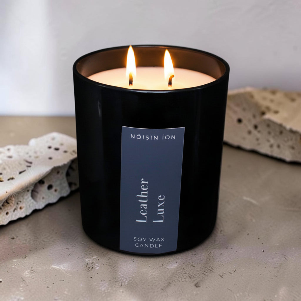 Lit Leather Luxe luxury soy wax candle in a black gloss jar with a dark navy label by Nóisin Íon.