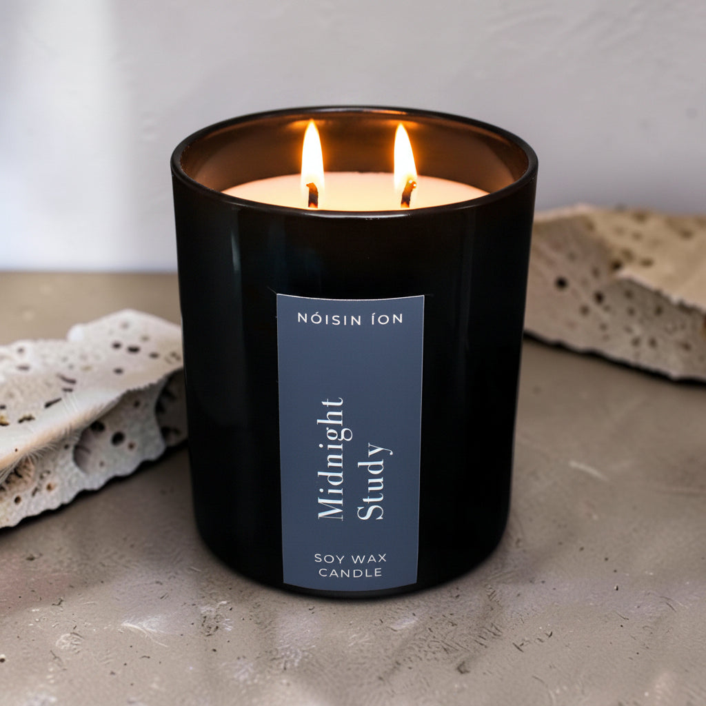 Lit Midnight Study luxury soy wax candle in a black gloss jar with a dark navy label by Nóisin Íon.