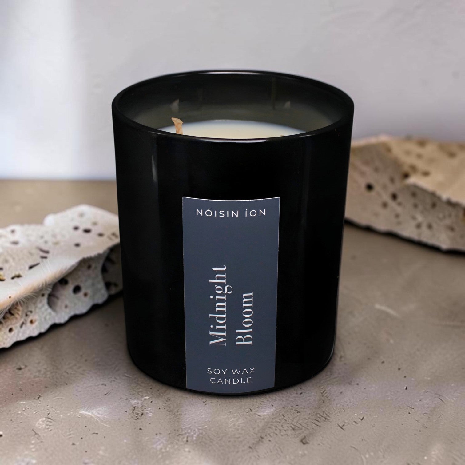 Midnight Bloom luxury soy wax candle in a black gloss jar with elegant floral fragrance by Nóisin Íon.