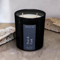 Peat & Cask luxury soy wax candle in a black gloss jar with a dark navy label by Nóisin Íon.