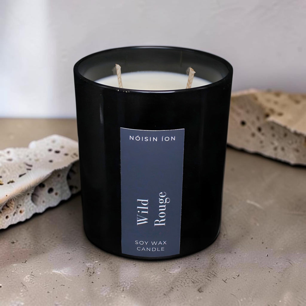 Wild Rouge luxury soy wax candle in a black gloss jar with a dark navy label by Nóisin Íon.